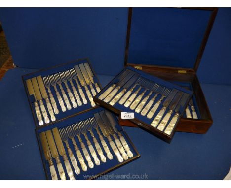 A wooden cased four tiered part Canteen of Cutlery with mother of pearl handles and family crest