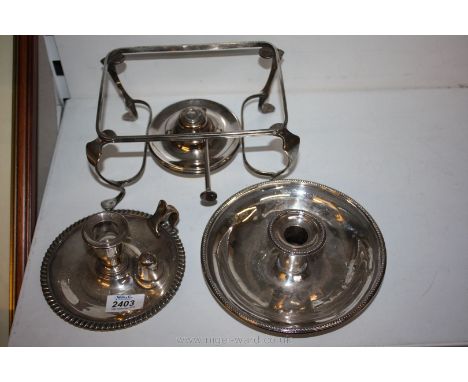 Two silver plate chamber sticks and a plated serving dish warmer complete with burner.