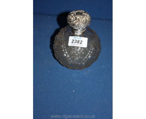 A Birmingham mark 1898 glass perfume bottle with a silver top and a glass stopper, 5 1/2" tall.