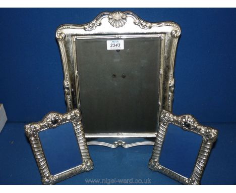 Two silver plated photograph frames, 7" x 5" and a large silver plated frame to take 10'' x 8'' photograph