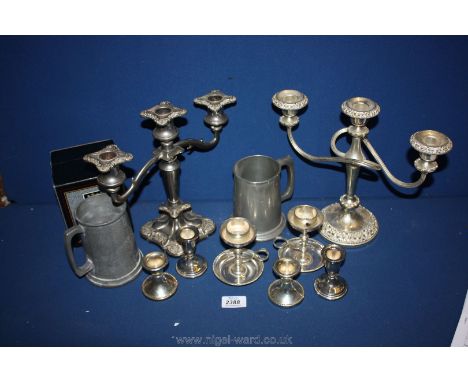 A quantity of silver plate including candlesticks, two candelabra, four tankards, etc.