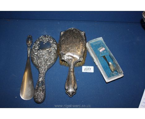 Three pieces of Birmingham silver to include dressing table mirror, brush and shoe horn along with a boxed baby toothbrush, m