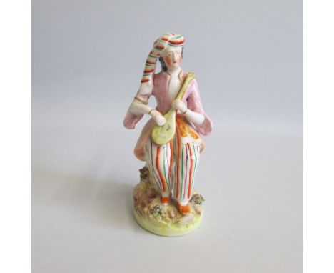 A Staffordshire Figure of a male musician playing a mandolin, dressed in a Turkish style seated on a tree stump.
Date: Circa 
