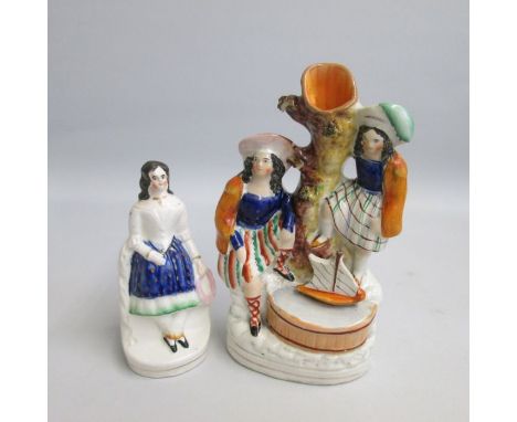 A Staffordshire spill figure of two children playing with a boat, along with a figure of a seated girl holding her bonnet and