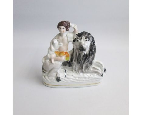 A Staffordshire Portrait Figure of The Peaceable Kingdom – Lion, child and lamb. (Isaiah 11:6).&nbsp; The lion sits on an ova
