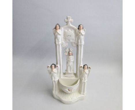 A Rare Staffordshire Portrait Figure of Christ with a cross behind his head and a rounded holy water stoup beneath an arch wi