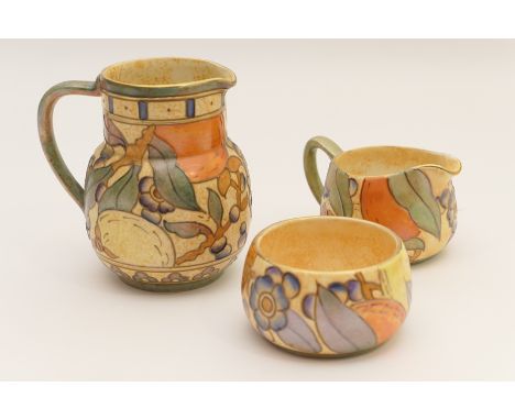 Bursley ware jug, decorated with tube lined fruits against a buff ground, pattern no. T.L.5, 13cm; also a similar milk jug an