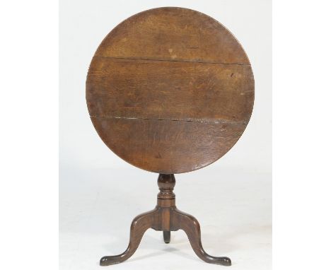 Late Georgian oak pedestal tripod table, the circular tilt top on a turned baluster column and three cabriole legs, 75cm diam