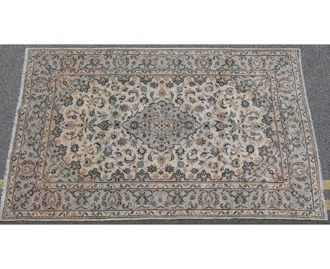 Kashan woollen carpet, the ivory field centred with a sage green medallion and sage green palmette border, size approx. 295cm