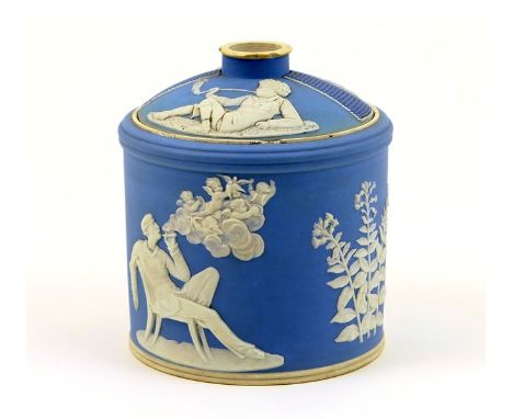 Wedgwood light blue jasperware tobacco jar and cover, cylinder form, the domed cover moulded with match strikers and decorate