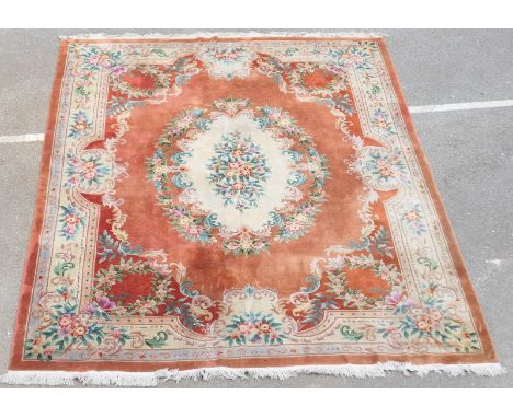 Chinese sculpted woollen carpet, in the Aubusson style, central floral fawn medallion against a terracotta ground and fawn fl