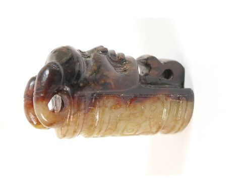 Finely carved celadon and brown jade pendant, with Taotie mask in relief on the celadon side and a Taotie mask sculpted on th
