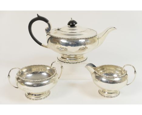 George V silver three piece tea service by Walker and Hall, Sheffield 1929, comprising teapot, milk jug and sugar basin, each