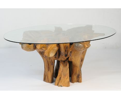Designer yewood and plate glass dining table, the oval top 211cm x 139cm, supported on an inverted trunk of yew, height 67cmN
