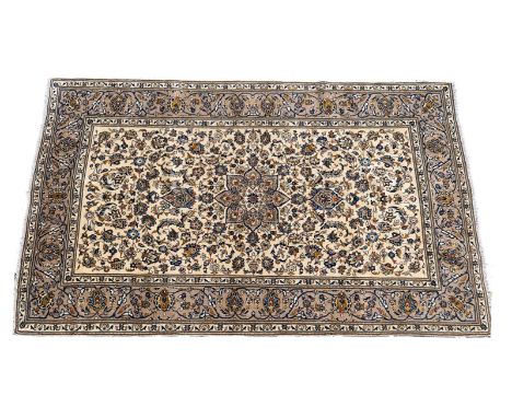 Kashan woollen carpet, ivory field centred with a flowerhead medallion dispersed with palmettes, within a fawn and blue palme