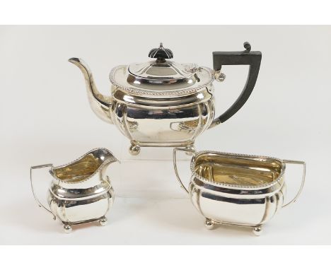 George V silver bachelor's three piece tea service, Birmingham 1922, comprising teapot, milk jug and sugar basin, each with g