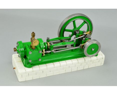 A HORIZONTAL SINGLE CYLINDER LIVE STEAM ENGINE, not tested, mounted on a re-painted brick effect wooden tank, some damage to 