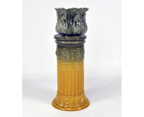 An early 20th century jardiniere stand with mustard and green glaze with raised pattern of shells and mythological figures, t