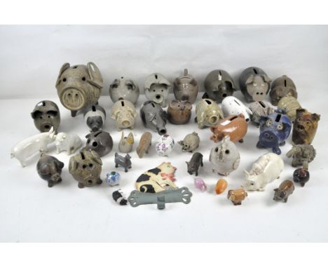 A large collection of model pigs, most being ceramic, of varying sizes and designs