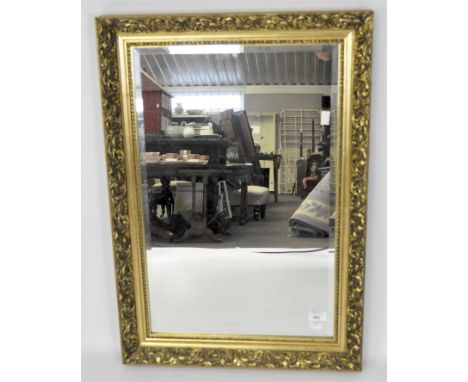 A gilt framed bevelled edged mirror of rectangular form, 77cm x 54cm