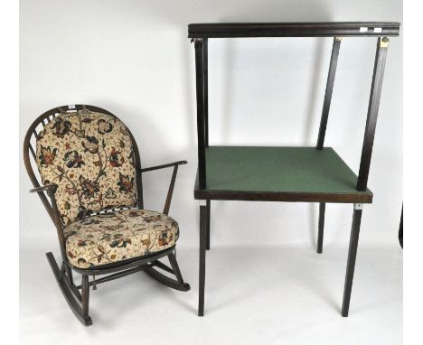 A stained beech Ercol rocking chair, with spindle backs and floral cushions, 85cm x 72cm x 77cm, together with two folding ca