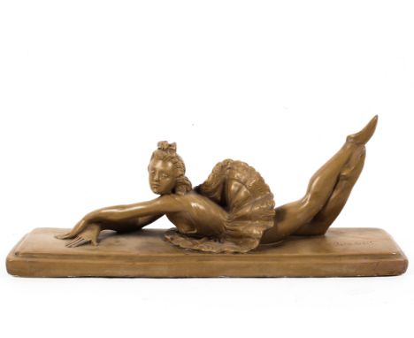 An Art Deco style plaster model of a reclining ballerina with etched signature to plinth, width 60cm.