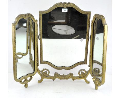 A gilt wood and gesso three part dressing table mirror with floral moulded frame, on scroll feet, 63cm high