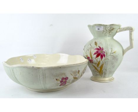 An early 20th century ceramic wash bowl and jug, decorated with pink floral scenes, with gilt leaves, Rd no 149641, height of