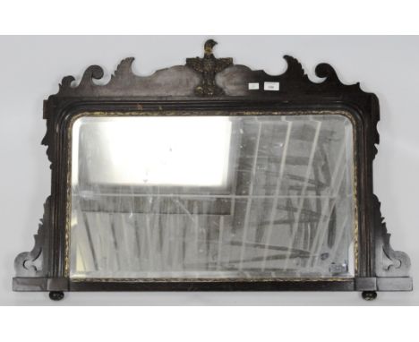 A Georgian style mahogany and parcel-gilt mirror, carved with a gilt eagle within scrolled frame, bevelled glass, 102cm x 67c