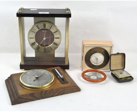 A group of clocks including a small Europa sun form clock, diameter 10.5cm, a vintage travel clock, a small clock in the shap