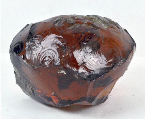 A piece of unusual amber coloured art glass of abstract form, 20cm wide