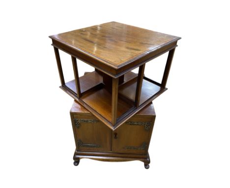 Unusual revolving bookcase above a lower cupboard. Light mahogany. Height 83 cm, top 51 sq cm Condition good  