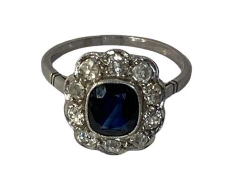 Platinum sapphire and diamond halo ring. Sapphire weight approximately 1ct. Diamond carat weight 0.50ct. Old cut diamonds. Cl