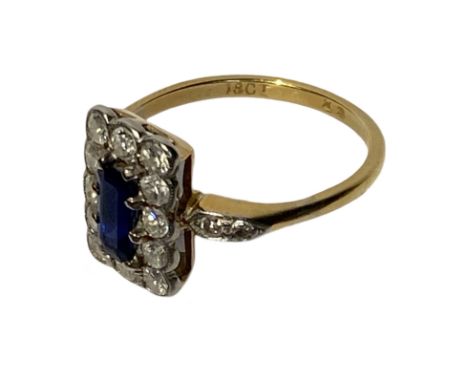 18ct yellow gold with platinum mount, sapphire and diamond ring. The central stone is a baguette cut sapphire total approx we