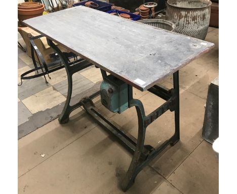 An industrial Bellow cast iron table base with associated slate top 