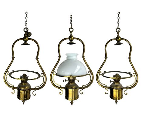 Set three brass framed light fittings, one with white glass shade, converted to electricity, H64cm