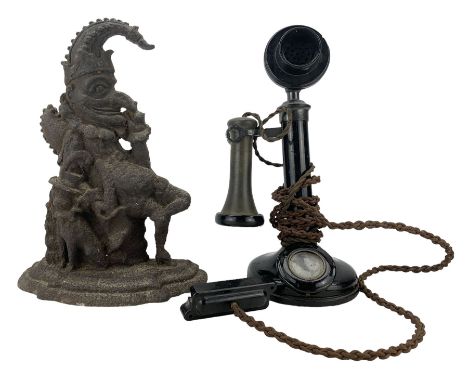 1920s candlestick telephone, with bakelite case, H32cm together with a cast iron doorstop in the form of Mr Punch (2)
