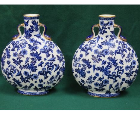 PAIR OF FLORAL DECORATED AND GILDED BLUE AND WHITE CERAMIC FLASKS, APPROXIMATELY 32cm HIGH (AT FAULT) 
