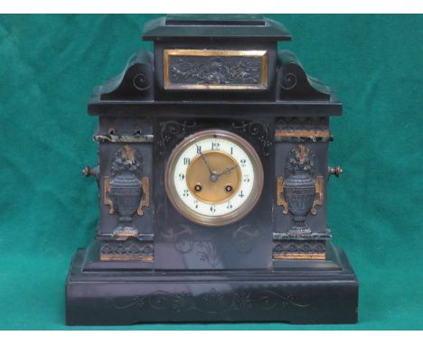 GILDED AND RELIEF DECORATED BLACK SLATE MANTEL CLOCK WITH ENAMELLED DIAL 