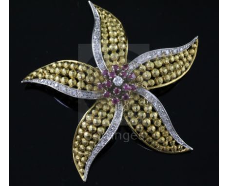 An 18ct gold, ruby and diamond set flower head pendant brooch, 55mm, gross 18 grams.