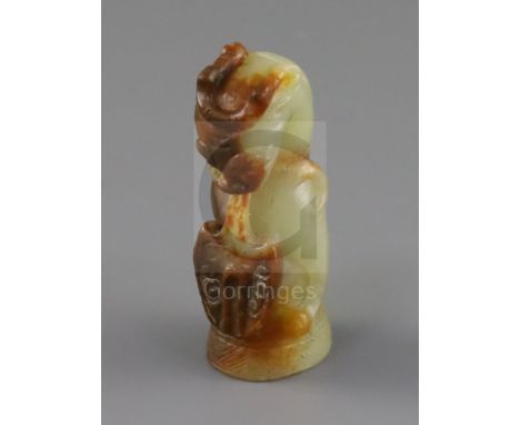 A Chinese pale celadon and russet jade finial, Song dynasty or later, carved in the form a lion with spade shaped tongue proj
