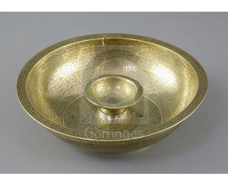 A large brass Persian magic bowl, Qajar dynasty, with inscribed decoration, Diam. 8.25in.