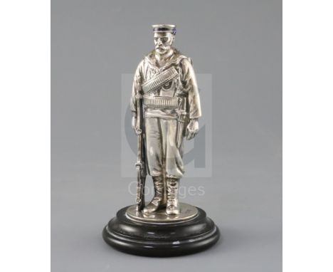 A late Victorian novelty silver and enamel inkwell, modelled as a sailor from HMS Duke of Wellington, the hinged body opening