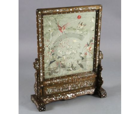 A Chinese embroidered silk, hongmu and mother of pearl framed table screen, c.1900, the embroidered panel decorated with bird