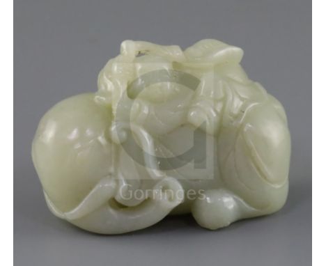 A Chinese pale celadon jade group of a boy on a recumbent elephant, 19th century, the boy clasping a sprig of lingzhi fungus,