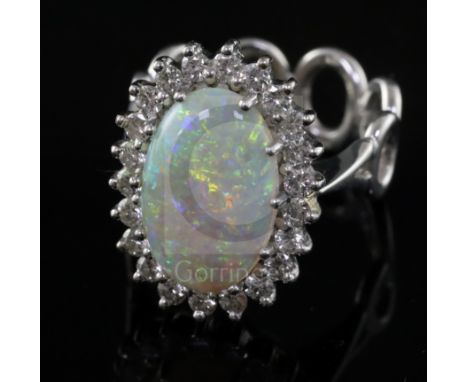 A modern 18ct white gold, white opal and diamond oval cluster ring, with unusual 'six ring' shank, size L.