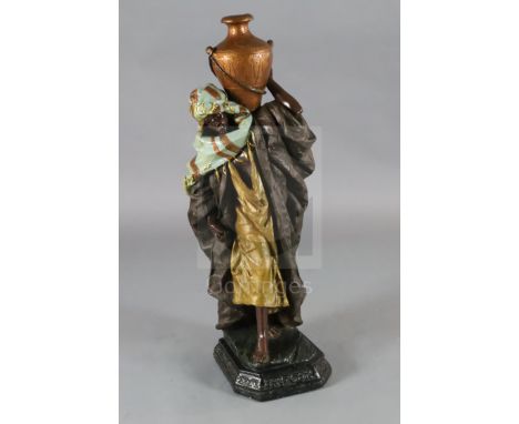 A Goldscheider style painted plaster figure of an Arab water carrier, H.40in.