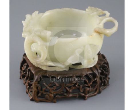 A Chinese pale celadon jade 'lotus' cup, late Ming dynasty, the cup formed as a lotus flower carved in high relief and open w