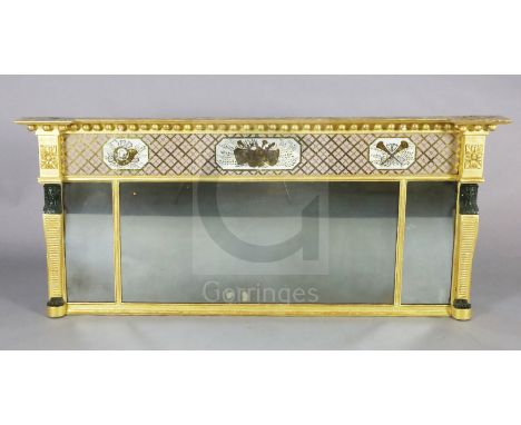 A Regency giltwood overmantel mirror, with ball frieze over an eglomise panel of musical trophies and triple plate flanked by