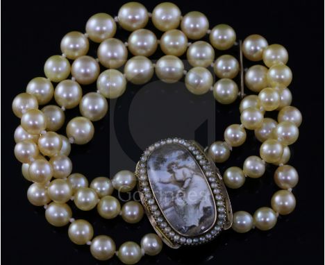 A triple strand cultured bracelet, now with a Regency gold mounted oval panel mourning clasp, decorated with a young lady wit